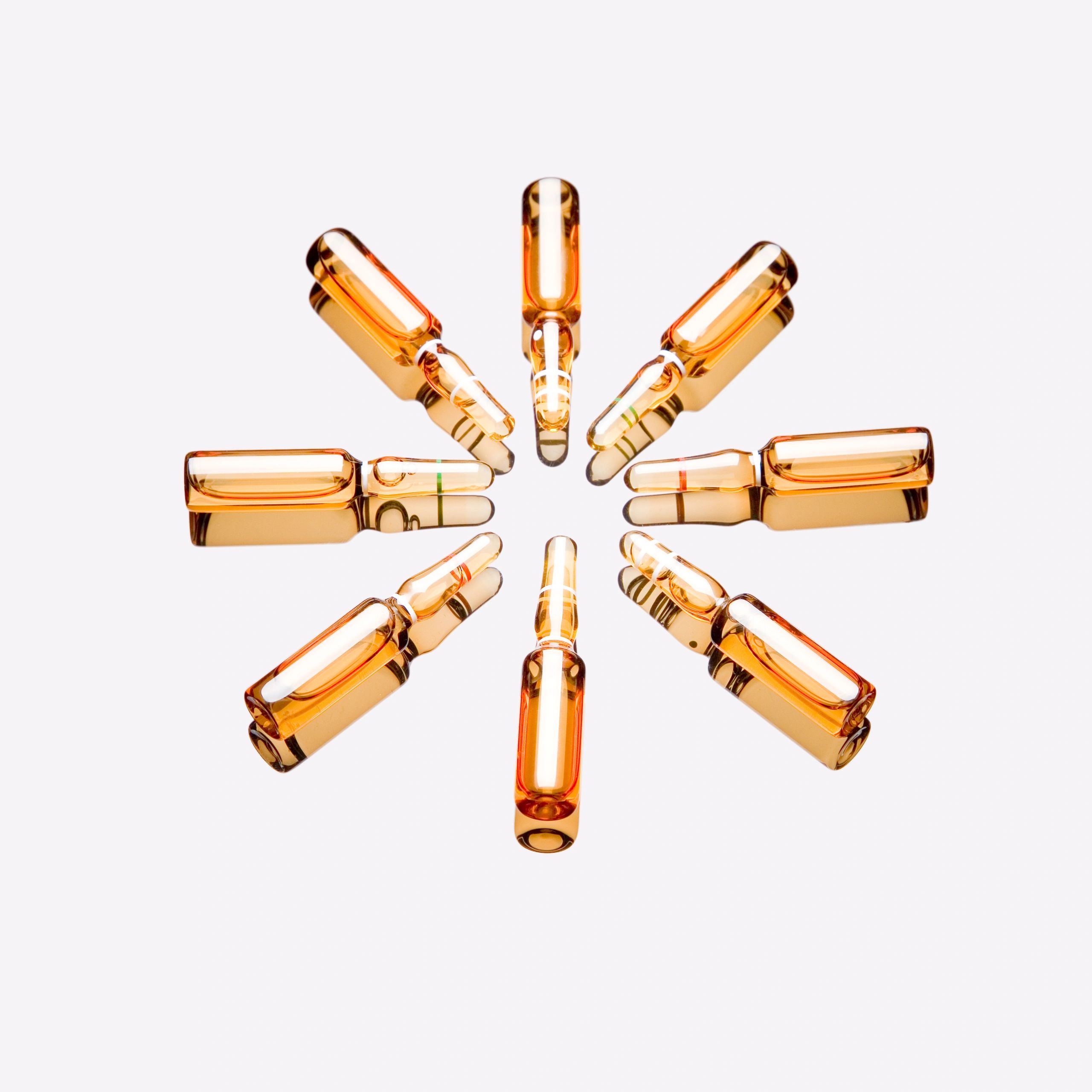 Medical ampules arranged on a white background